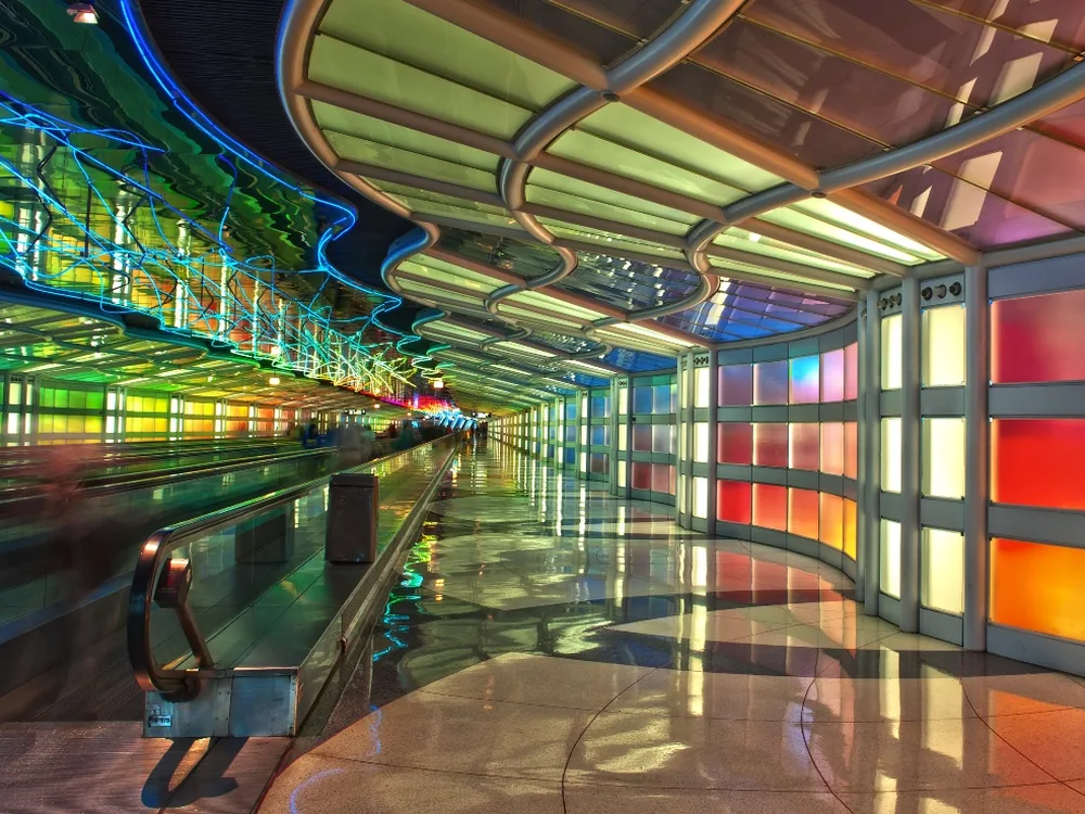 The illuminated neon walkway tunnel between concourses at O'Hare International Airport
