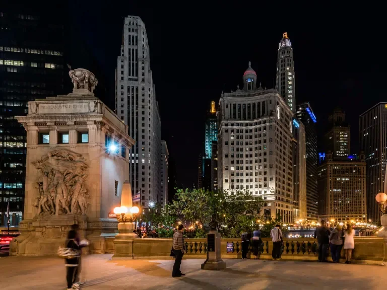 Michigan Avenue Bridge plaza at night with the Wrigley Building and Tribune Tower